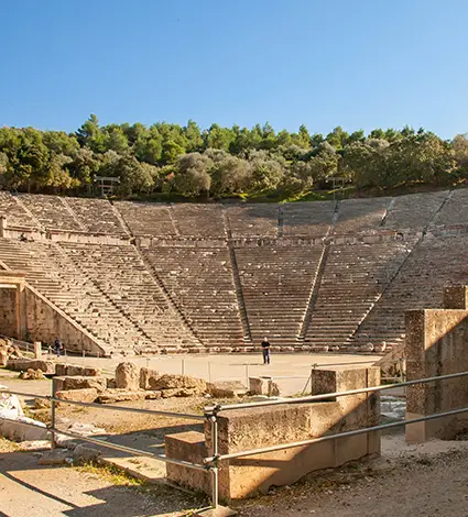 The ancient, stone theatre in Epidaurus and part of the backstage building