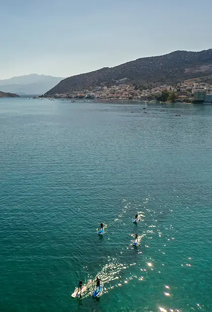 Two people windsurfing in Tolo bay