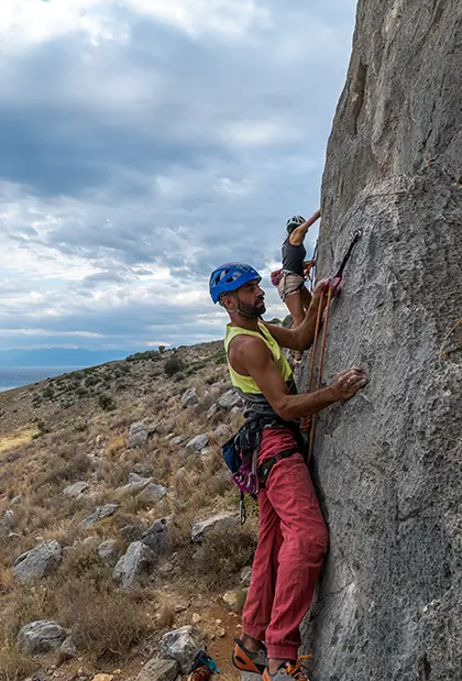 People Climbing on Big Gray Rocks