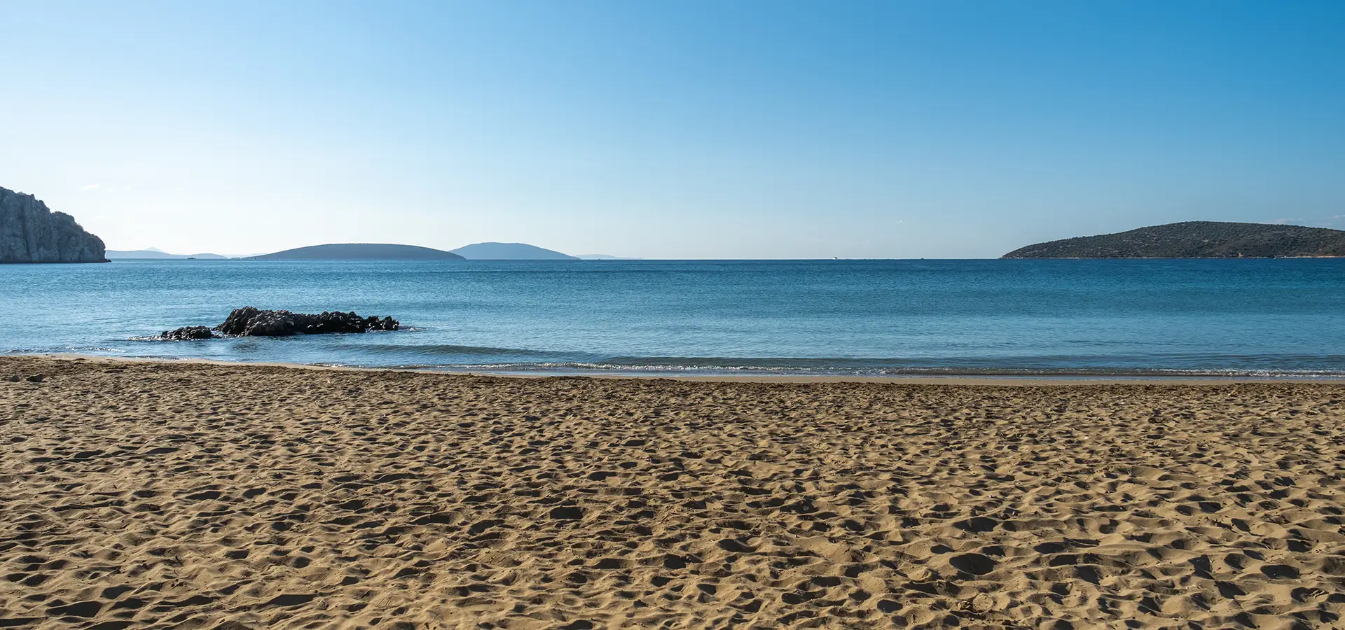 Sand, sea and sky at Tolo beach